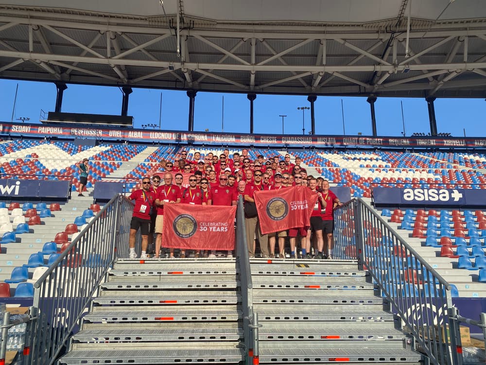 The VMFC squad in the stand at Valencia holding Celebrating 30 Years flags